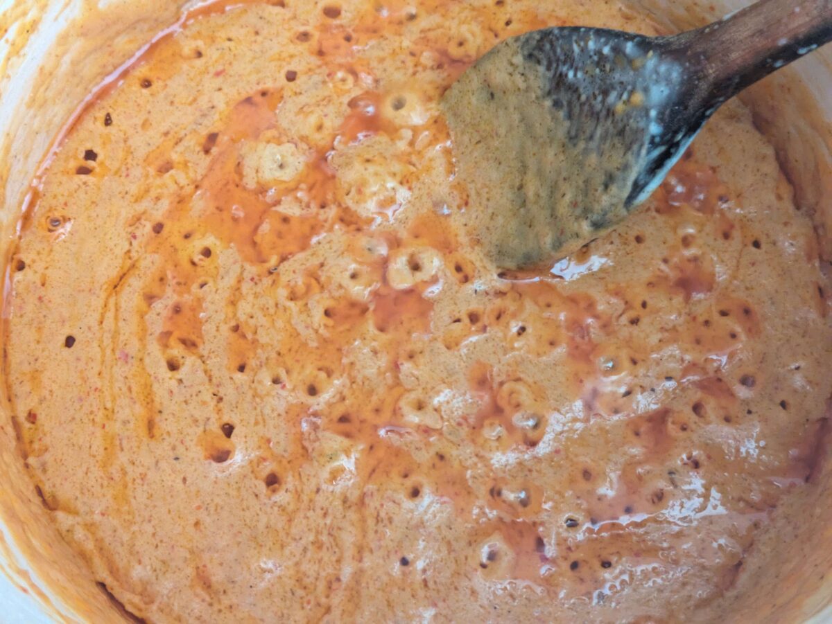 Red curry paste sizzling in coconut cream — the foundation of rich, aromatic Thai peanut sauce.”