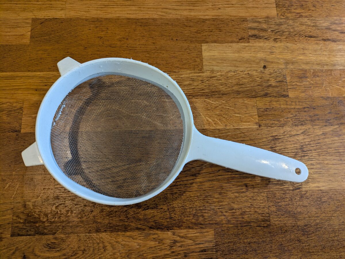 A strainer used to remove seeds from tamarind water