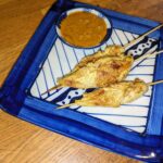 "Grilled Thai chicken satay skewers served with Homemade peanut sauce"