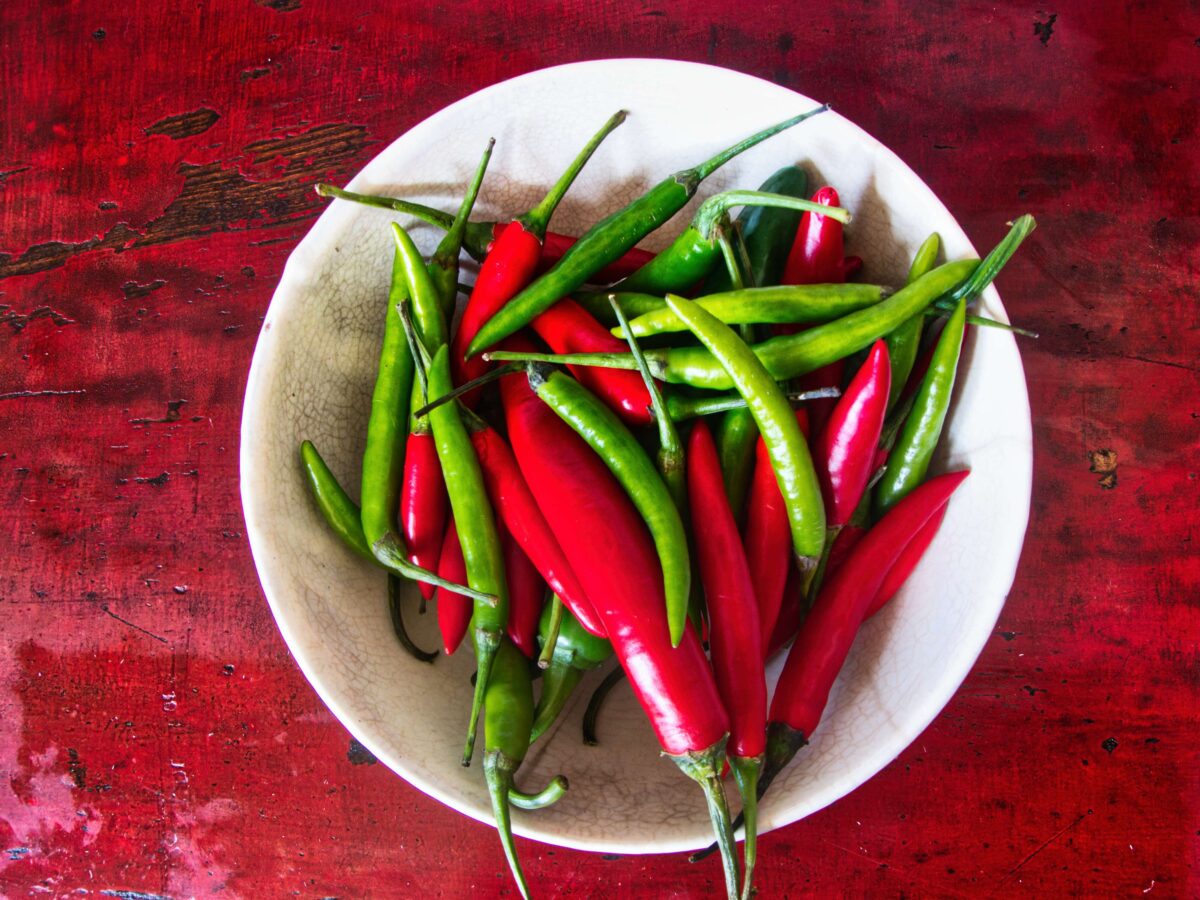 “Assorted Thai chillies — bird’s eye, spur, and mild red — commonly used in Thai curries and sauces.”