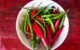 “Assorted Thai chillies — bird’s eye, spur, and mild red — commonly used in Thai curries and sauces.”
