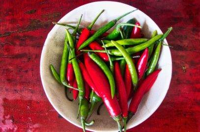 “Assorted Thai chillies — bird’s eye, spur, and mild red — commonly used in Thai curries and sauces.”