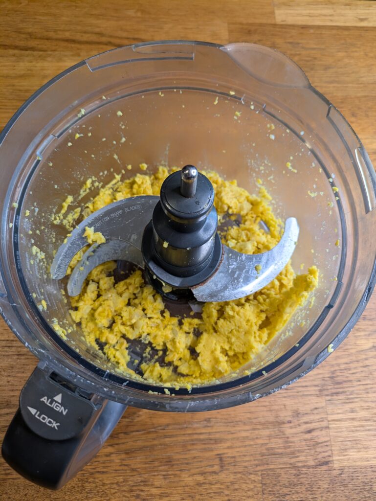 “Corn kernels being blended in a food processor for Thai corn fritters.”