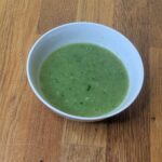 Thai hot chilli dressing in a bowl with green chilli, garlic and lime