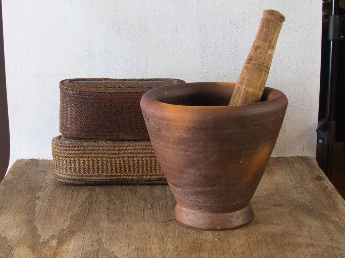 Clay mortar and wooden pestle used for pounding ingredients