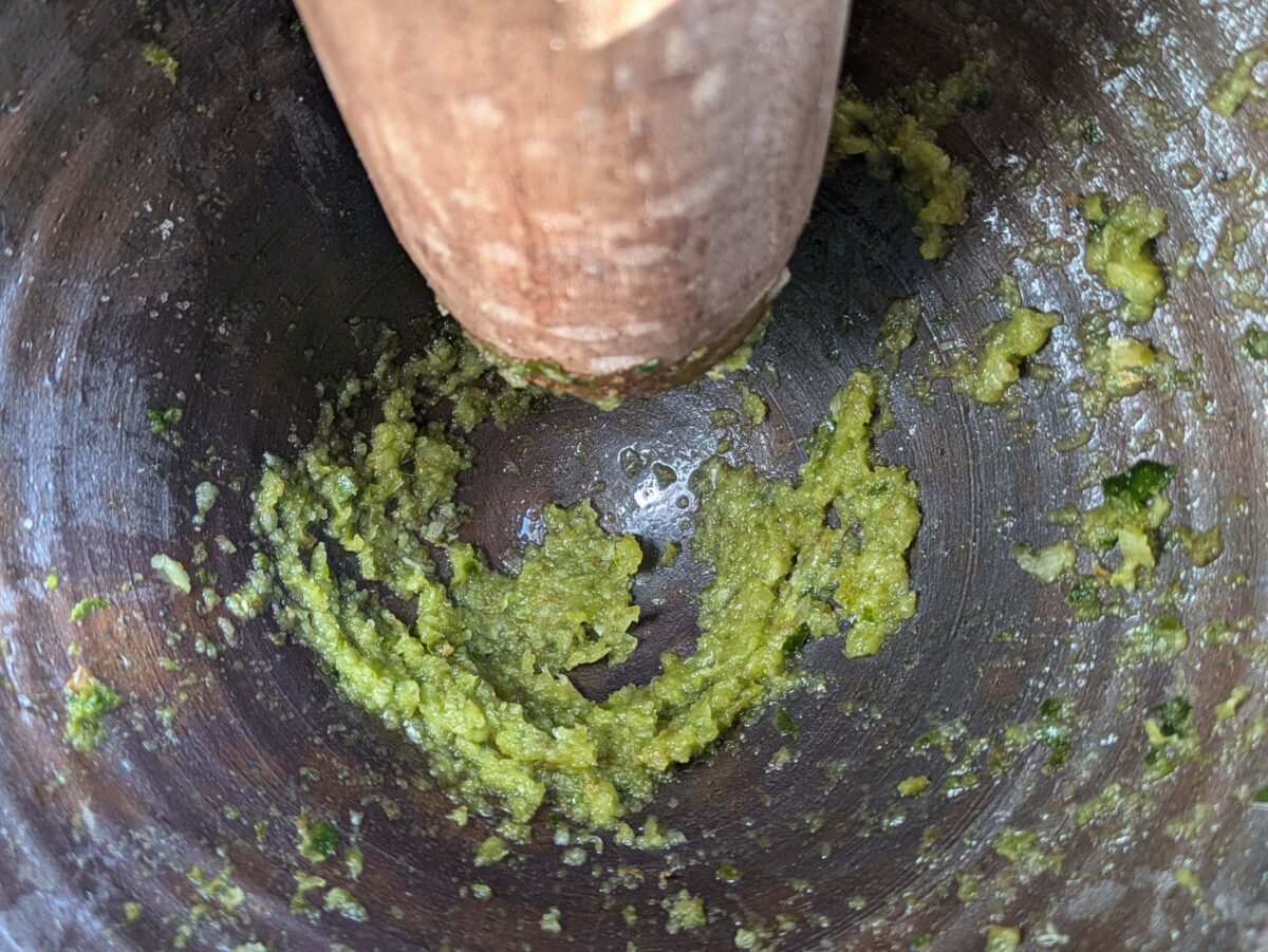 Garlic and chilli paste in a mortar, ready for lime juice and fish sauce to be added