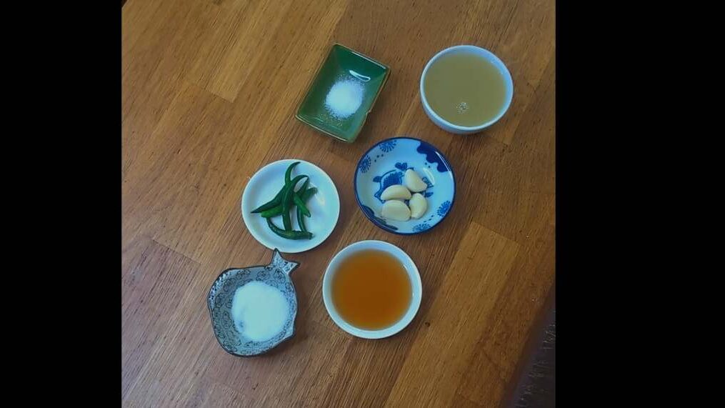 Ingredients for Thai hot chilli dressing including green chillies, garlic, lime juice, fish sauce and sugar